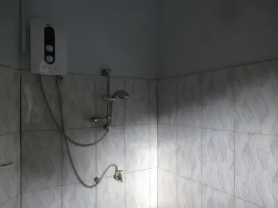a shower in a bathroom with a shower head at Darema Homestay in Arusha