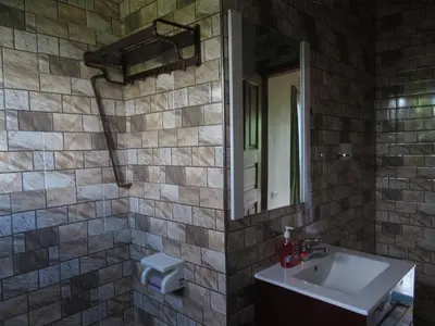 a bathroom with a sink and a mirror at Darema Homestay in Arusha