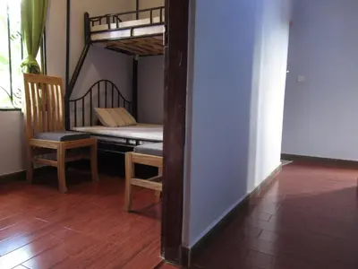 a room with a bunk bed and a chair at Darema Homestay in Arusha
