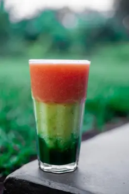 a glass filled with a slice of watermelon at Shose Farmhouse Chalets & Campsite in Moshi
