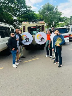 a group of people standing in front of a food truck at Safari villa in Arusha