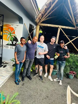a group of men standing in front of a building at Safari villa in Arusha