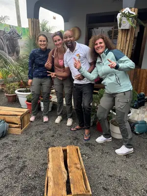 a group of people standing next to a wooden bench at Safari villa in Arusha