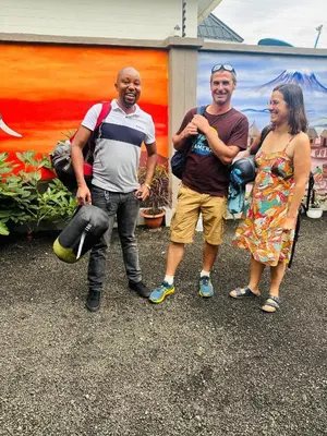 a group of three people standing in front of a building at Safari villa in Arusha