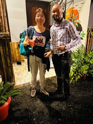 a man and a woman standing in front of a house at Safari villa in Arusha