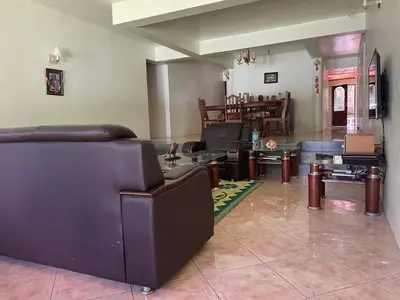 a living room with couches and tables in a room at Joe & El Heritage Villa in Mwika
