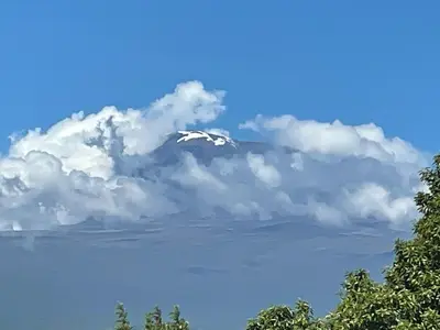 a mountain covered in clouds in the sky at Joe & El Heritage Villa in Mwika