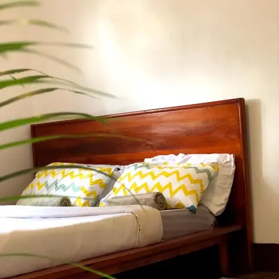 a bed with several pillows on top of it at Goodtimewithfar House in Moshi