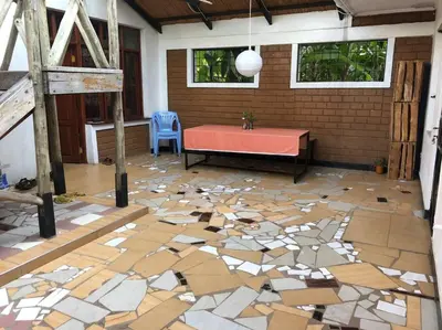 a room with a table and a floor covered in tiles at The Hondo Hondo House, Mto wa Mbu, Tanzania in Mto wa Mbu