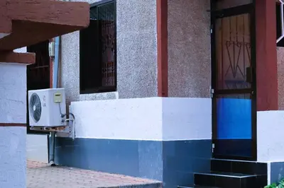 a building with a blue and white wall and a door at Otakef Motel in Arusha